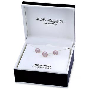 Sterling silver necklace with three pink freshwater pearls, displayed in a box labeled \“R.H. Macy & Co. Fine Jewelry.\“