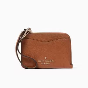 A brown Kate Spade crossbody bag with a zippered top and shoulder strap.