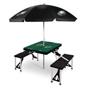 Folding picnic table with attached benches, featuring a football field design and black umbrella with eagle logos.