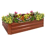 A wooden raised garden bed planter filled with colorful flowers, including yellow, pink, orange, and purple blooms, along with green foliage.