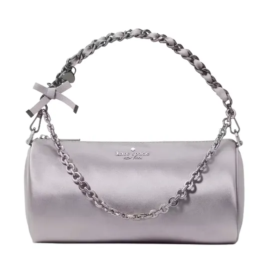 A metallic silver Kate Spade New York barrel bag featuring a chain strap and a small bow accent.
