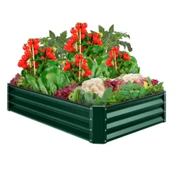 A raised metal garden bed filled with ripe tomatoes, spinach, cauliflower, lettuce, and various herbs.