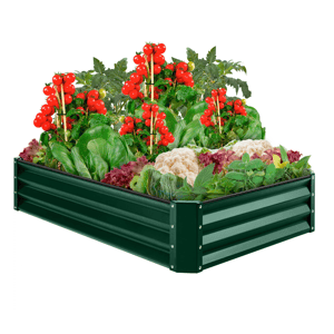 A raised metal garden bed filled with ripe tomatoes, spinach, cauliflower, lettuce, and various herbs.