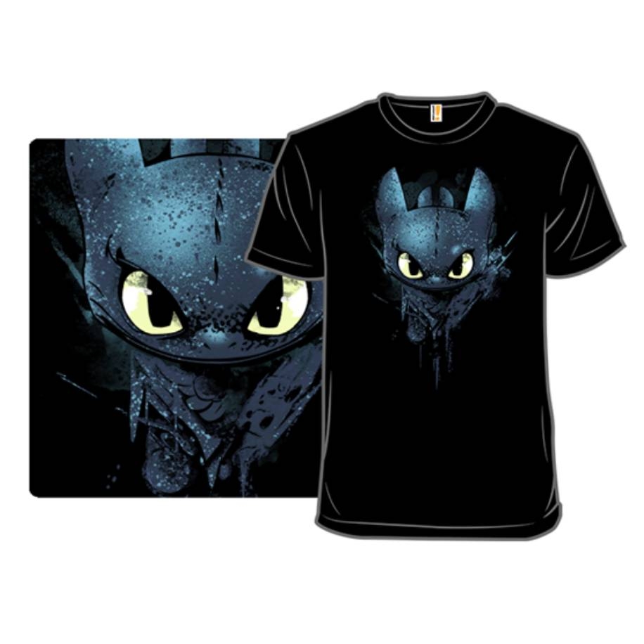 A black T-shirt featuring a stylized design of a dragon with large yellow eyes on the front.