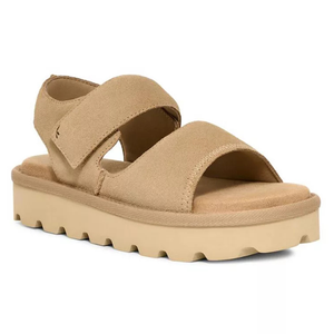 Tan sandal with a thick sole, featuring two wide straps and textured tread, designed for comfort and casual wear.