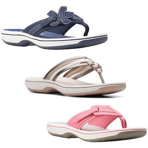 Three different styles of women's sandals: top - navy with a floral accent, middle - champagne with straps, bottom - pink with a cross-strap design.