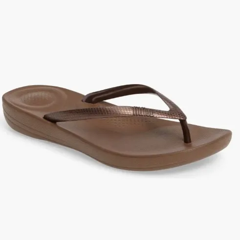 A single brown flip-flop with a thong strap.