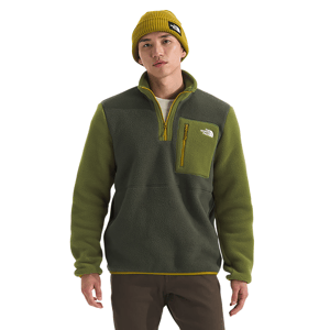 A man wears an olive green fleece pullover with a yellow zipper and chest pocket, paired with a mustard beanie.