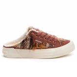 A brown slip-on sneaker with a fuzzy, multicolored fabric design and a cream-colored sole, featuring fur lining for added warmth.
