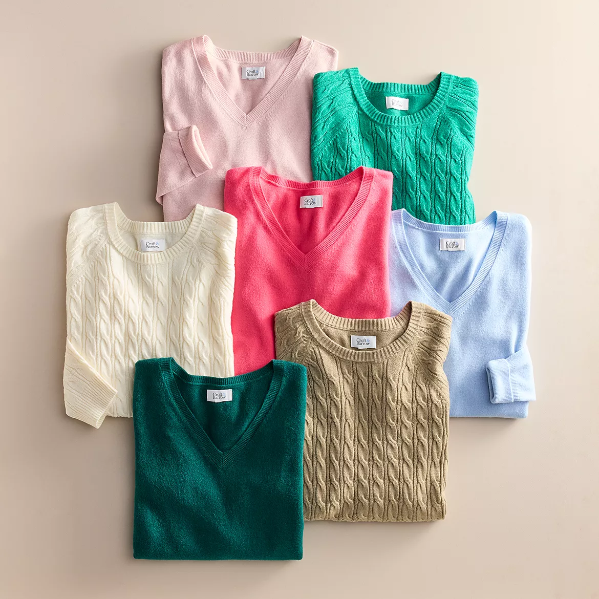 Seven Croft & Barrow V-neck sweaters in various colors—pink, green, white, red, blue, lavender, and dark green—with cable knit patterns are displayed.