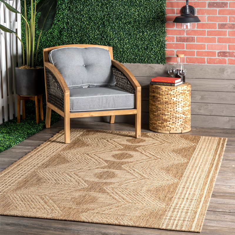 5' x 8' area rug with a textured geometric pattern in earthy tones, suitable for indoor or outdoor use.