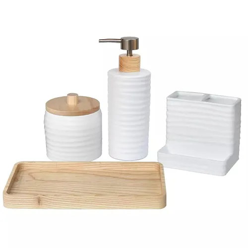 Bathroom accessory set with a soap dispenser, toothbrush holder, lidded jar, and wooden tray, all featuring a white, ribbed ceramic design combined with light wood accents.