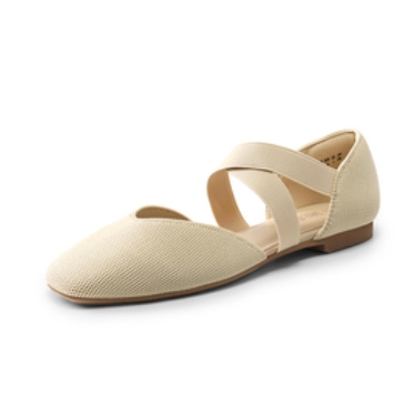 Beige flat shoe with a closed toe and crisscross elastic straps, featuring a low heel and textured upper.