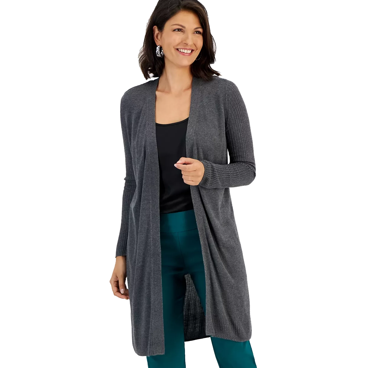 A woman is wearing a long gray open-front cardigan over a black top and teal pants.