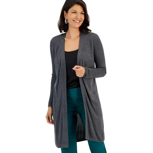 A woman is wearing a long gray open-front cardigan over a black top and teal pants.