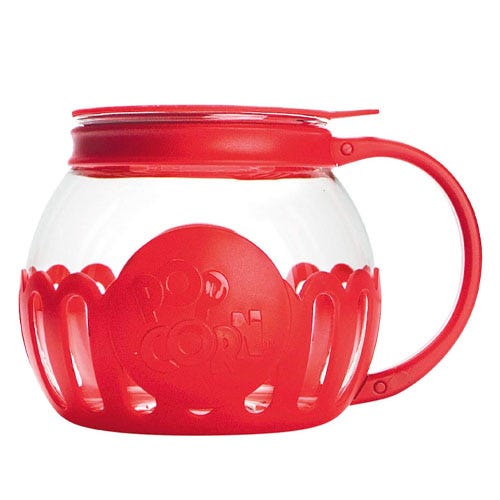 A red and glass container designed for popping popcorn.