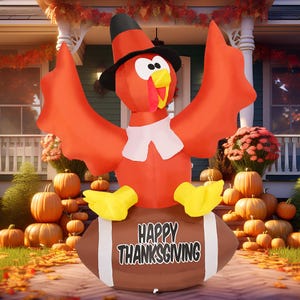 Inflatable turkey decoration with a pilgrim hat and \“Happy Thanksgiving\“ message on a football, surrounded by pumpkins and autumn foliage.