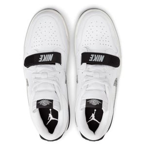 A pair of white Air Jordan shoes with black accents and the Jumpman logo on the tongue.
