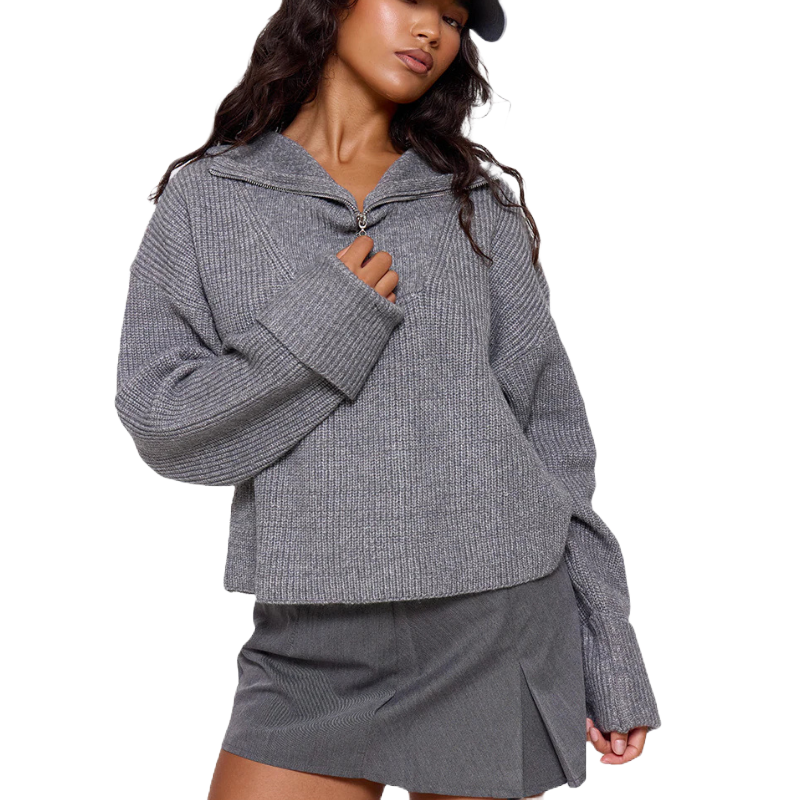 A cozy, gray chunky knit sweater with a half-zip design and oversized sleeves, paired with a matching gray skirt.