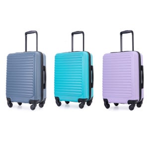 Three hard-shell suitcases with telescoping handles and wheels, in grey, teal, and lilac colors.