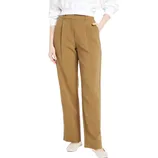 A person is wearing high-waisted, brown, wide-leg trousers with pleats, a tucked white sweater, and white shoes.