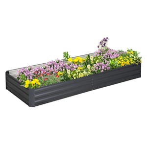 A rectangular black metal raised garden bed filled with various colorful flowers.
