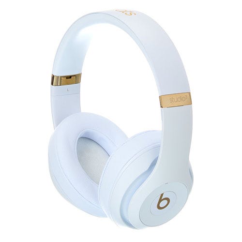White over-ear headphones with gold accents, featuring the \“b\“ logo on the ear cup and \“studio³\“ branding on the headband.