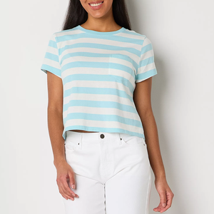 A woman wearing a blue and white striped cropped t-shirt with white jeans.