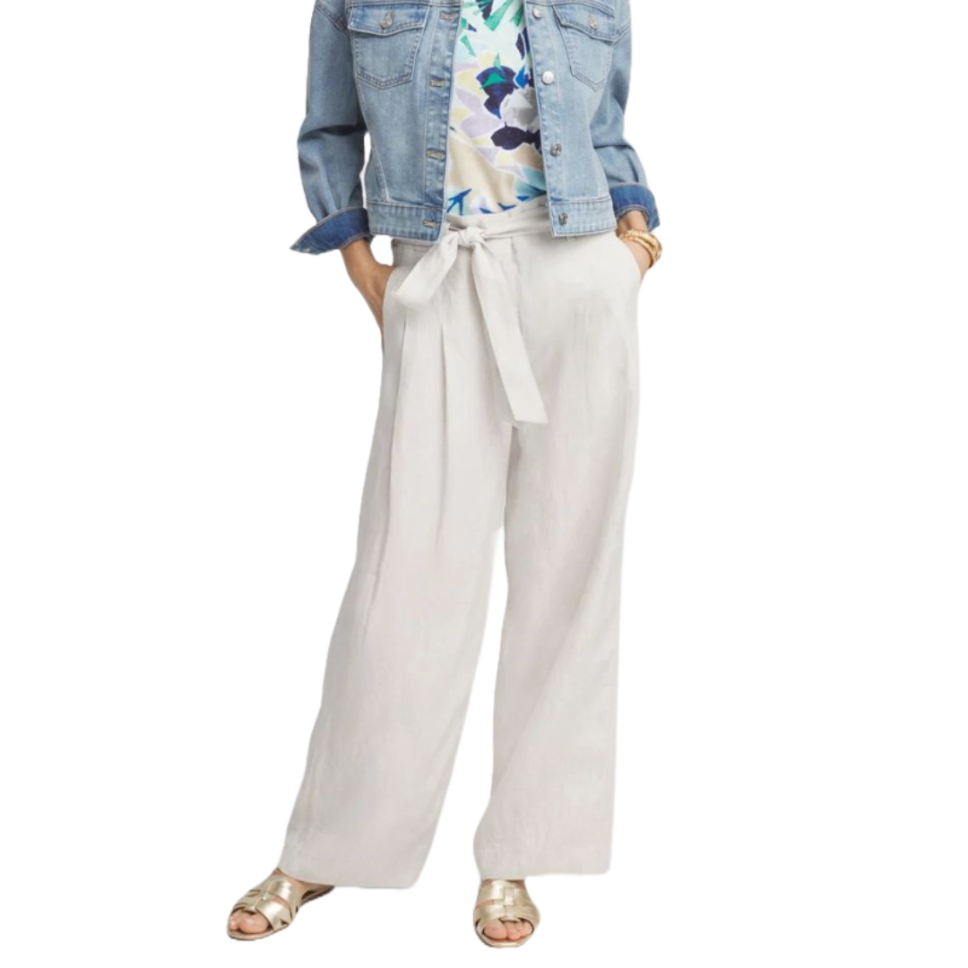 Wide-leg linen pants with a high Hollywood waist, featuring a tie belt and two front pockets, in a light, airy fabric. They are paired with a denim jacket, floral top, and gold sandals.