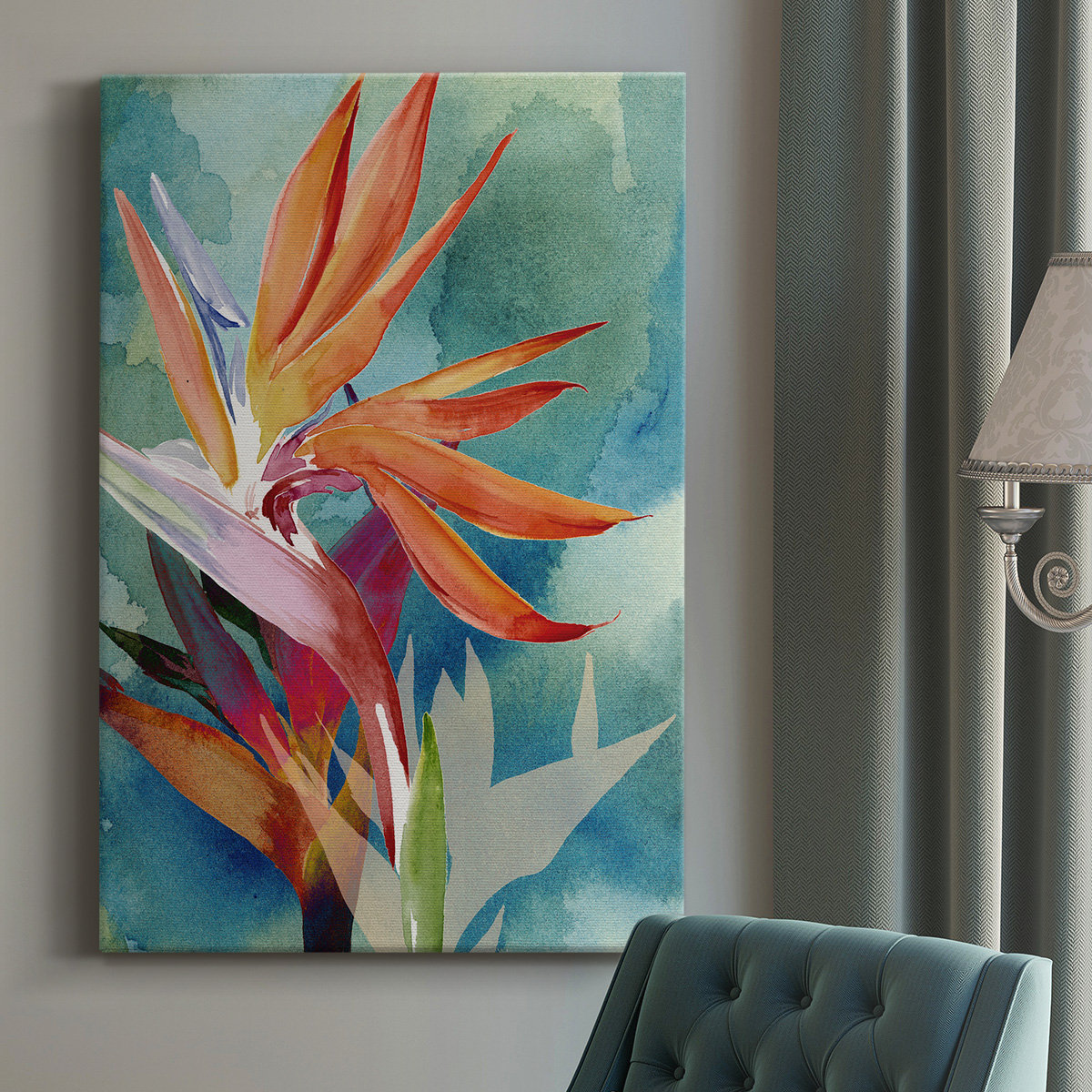A vibrant botanical canvas art piece featuring orange and red floral elements on a blue-green background, mounted on a wall next to a blue upholstered chair and a decorative lamp.