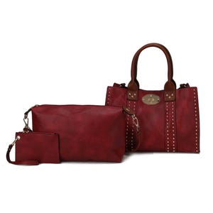 A 3-piece set featuring a red MKF shoulder bag with brown handles and stud accents, accompanied by a large zippered pouch and a small wristlet, all in matching red.