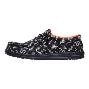 Black lace-up shoe featuring a pattern of skeletons, snakes, and mythical creatures, with an orange interior lining.