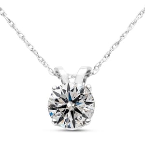 A silver necklace featuring a round, faceted gemstone in a prong setting, hanging on a delicate chain.