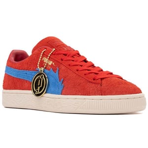 Puma x One Piece Shoes feature a red suede upper with a blue wave detail, complemented by a cream-colored sole. They include a gold medallion keychain and Puma branding.