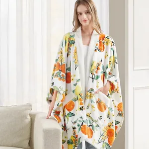 A person wearing a white robe with a colorful citrus fruit pattern.