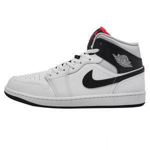 A white and black Nike Air Jordan 1 Mid sneaker featuring the classic Air Jordan wings logo on the side and a red detail on the tongue.