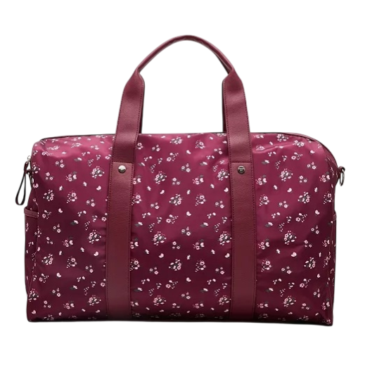 A burgundy floral-patterned duffle bag with two sturdy handles and a zippered closure, featuring small white flowers.