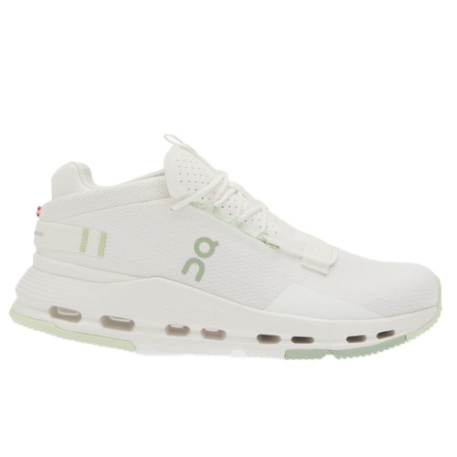 A white athletic sneaker with a soft green sole and laces, featuring a visible cushioning system and a subtle design logo on the side.