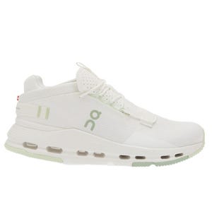 A white athletic sneaker with a soft green sole and laces, featuring a visible cushioning system and a subtle design logo on the side.