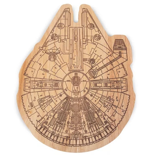 A wooden cutting board shaped like a spaceship with intricate engravings resembling a detailed floor plan.