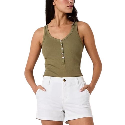 A woman wears a sleeveless olive green henley tank top with white shorts, featuring a button detail on the top and side pockets on the shorts.