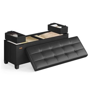 A black storage ottoman with a tufted removable lid reveals interior compartments divided into sections, with two smaller boxes on top for organizing items like blankets and other accessories.