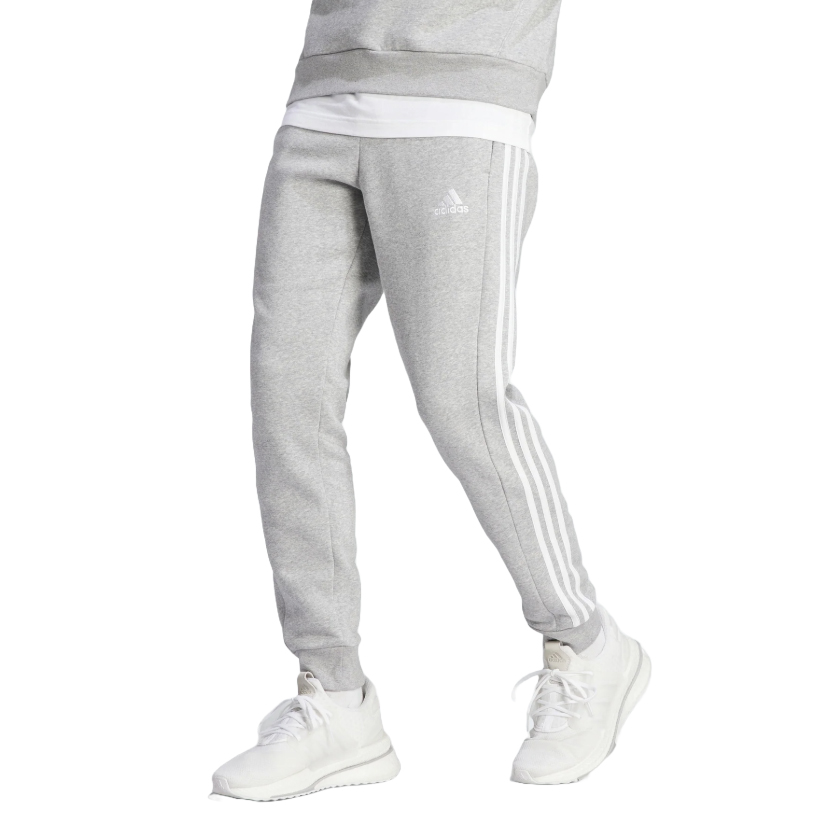 Gray Adidas men's fleece pants with white side stripes and the Adidas logo on the thigh, paired with white sneakers.