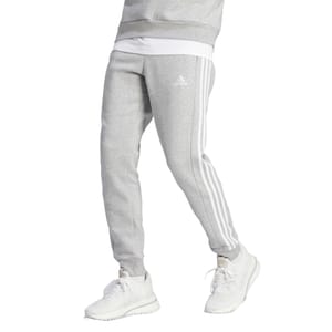 Gray Adidas men's fleece pants with white side stripes and the Adidas logo on the thigh, paired with white sneakers.