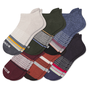 A collection of six multicolored ankle socks featuring different patterns, including stripes and hexagons, with varying color schemes such as beige, green, blue, maroon, orange, and purple.