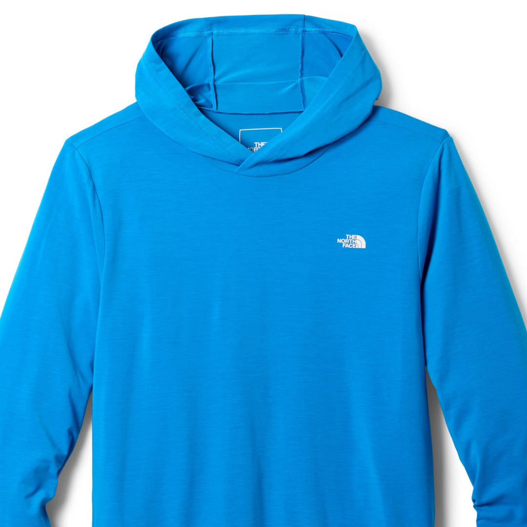 Bright blue long-sleeve hoodie from The North Face with a small white logo on the chest. Designed for sun protection, featuring a lightweight and breathable fabric.