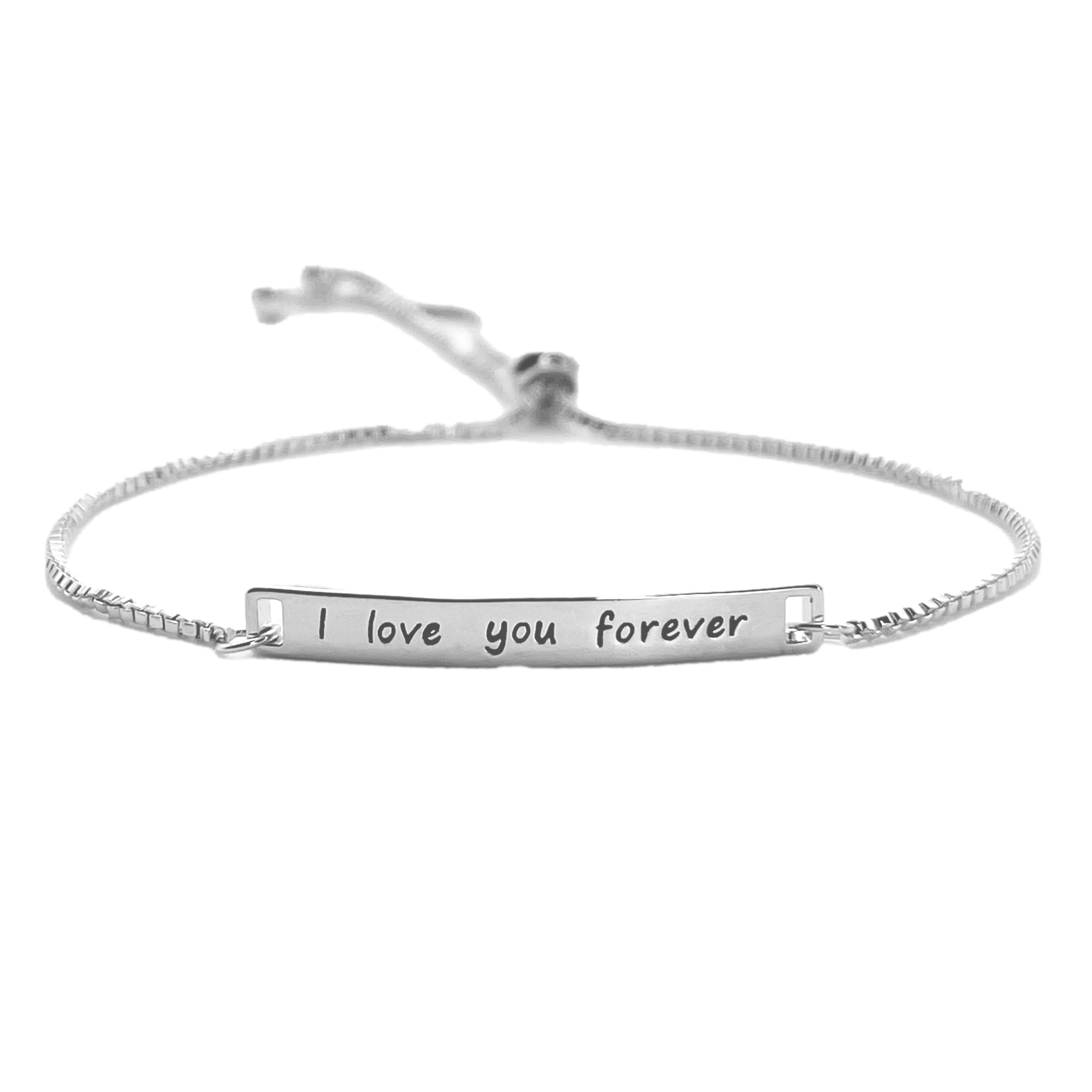 A silver bracelet with a simple chain and an engraved plate reading \“I love you forever.\“