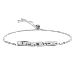 A silver bracelet with a simple chain and an engraved plate reading \“I love you forever.\“