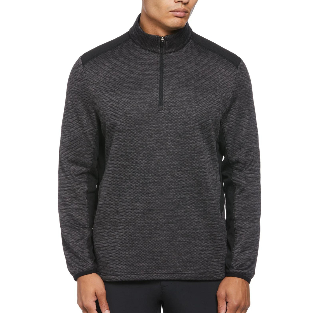 A man wearing a dark gray, half-zip pullover sweater with a high neck and long sleeves.