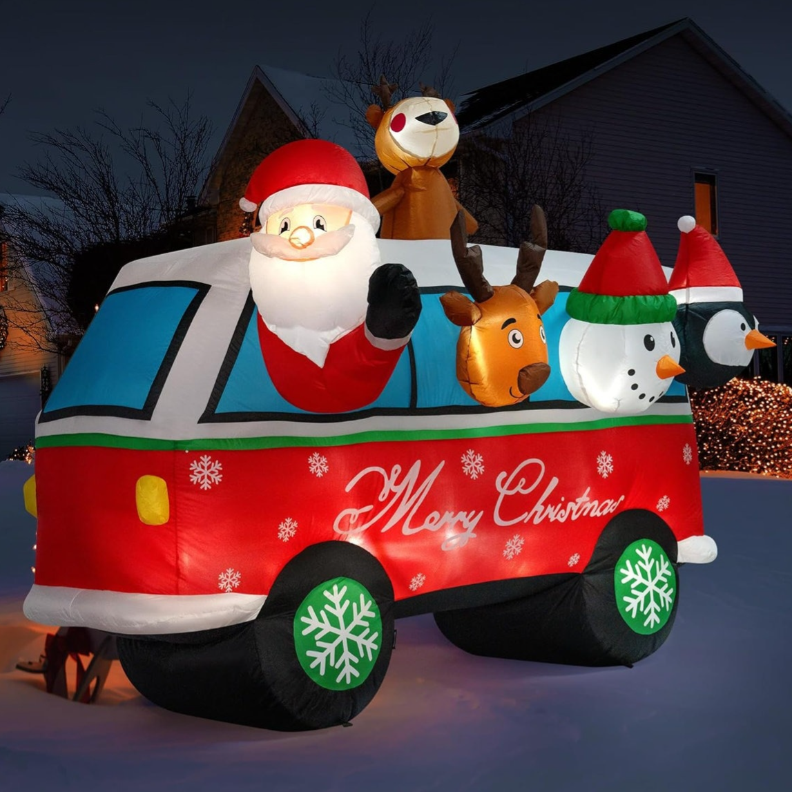 Inflatable Christmas decoration featuring a red van with snowflakes and \“Merry Christmas\“ text, with Santa, a reindeer, a snowman, and a penguin.